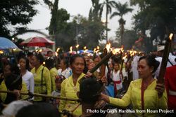 Group of Indonesian Hindu women with torches with lit flames marching during Nyepi day bG7Reb