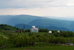 Observatory domes in green valley