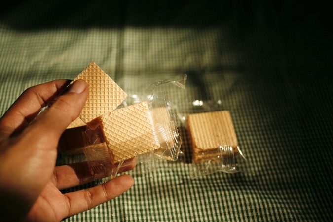 Hand reaching for package of wafers