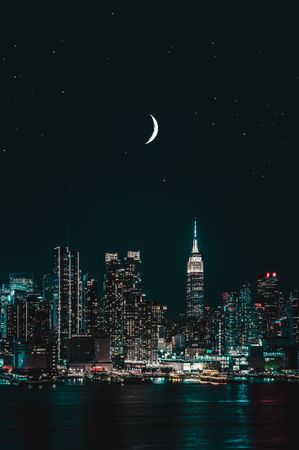 Crescent moon in New York city skyline during night time
