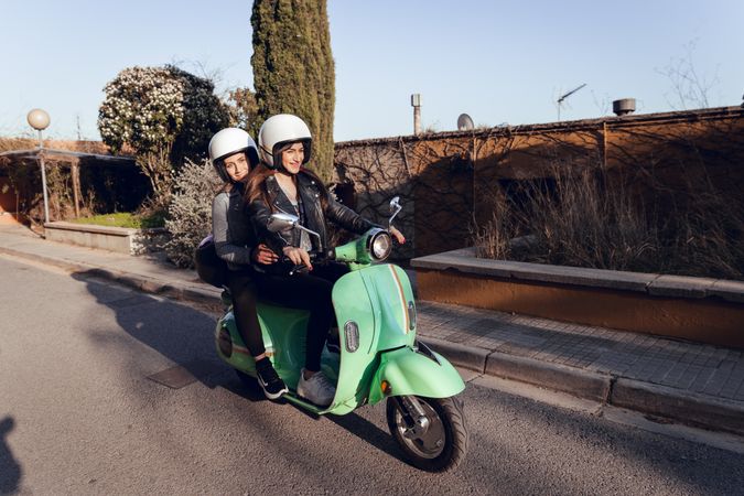 Young people riding motorcycles on city road