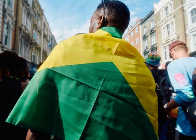 Back of Black man draped in Jamaican flag