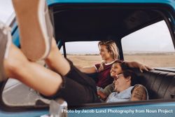 Women friends enjoying traveling by a car 49Zpmb