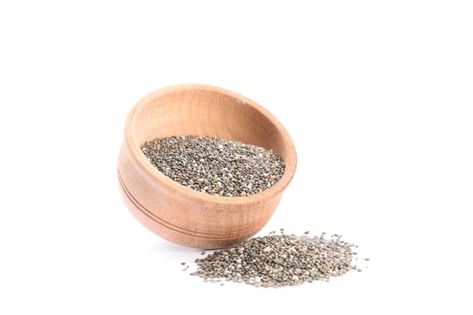 Chia seeds and wooden bowl isolated on blank background