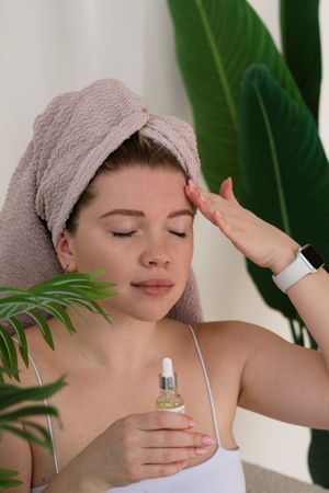 Young woman with skincare non-comedogenic facial massage oil