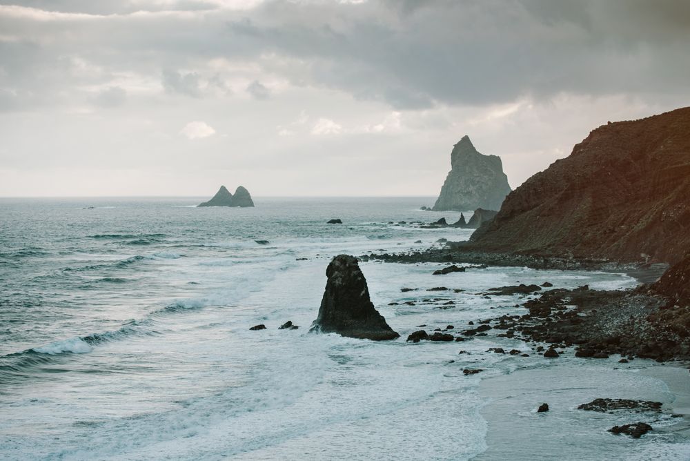 Lonely cliff in sea on cloudy day