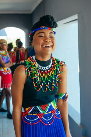 Zulu wedding bridesmaid laughing and smiling with eyes closed