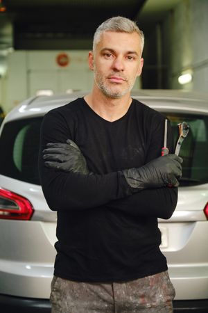 Confident mechanic in garage