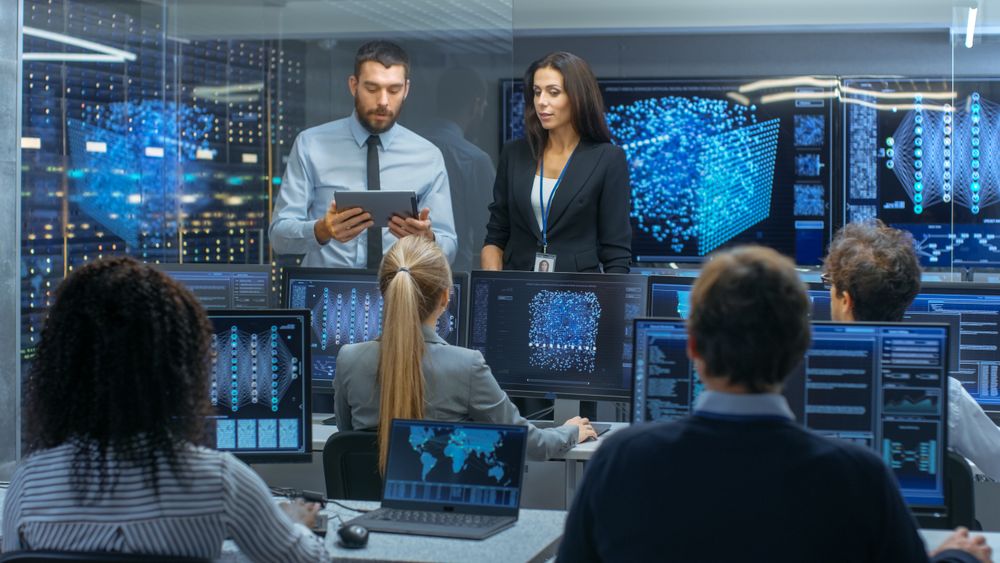 Head of the Department and Project Manager Discuss Work Process Using Data on Tablet Computer.