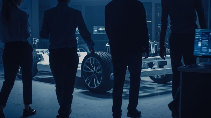 Team of Automobile Design Engineers Enter Automotive Innovation Facility Start Working on Electric Car Platform Chassis Prototype