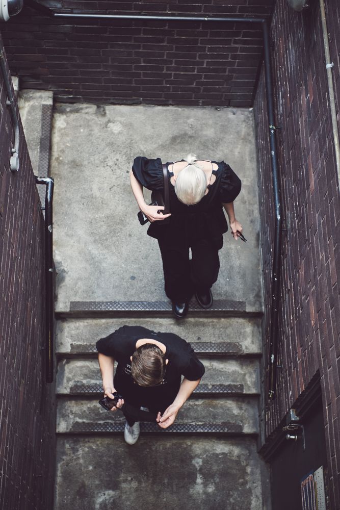 London, England, United Kingdom - September 18 2021: Two people walking down stairs