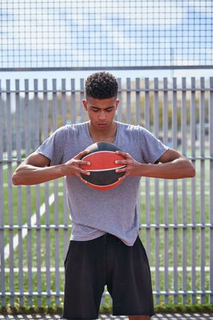 Portrait of young man with basketball