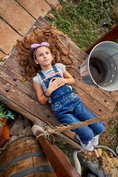 Girl lying in backyard in countryside
