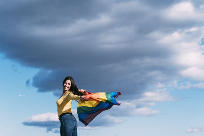 Young woman with gay pride flag