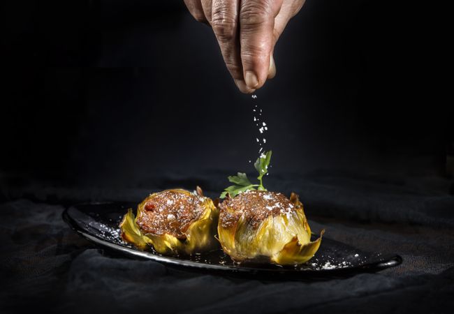 Delicious baked artichokes on plate