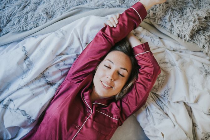 Woman sleeping and smiling in bed