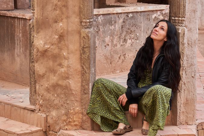 Woman on street between ancient buildings