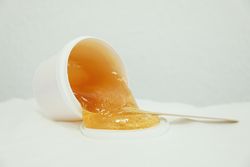 Liquid yellow paste for sugaring on blank background