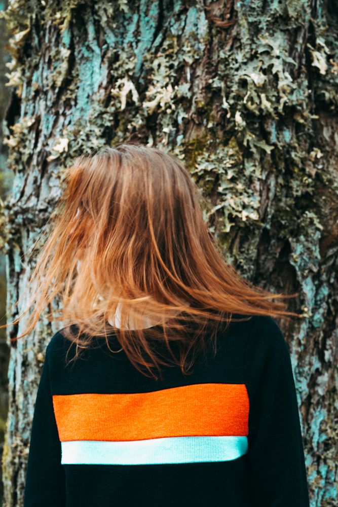 Casual redhead woman shaking with hair