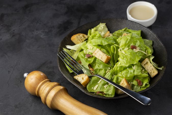 Caesar salad with croutons and bacon.