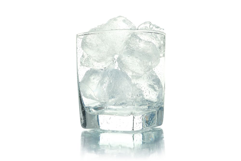 Square rocks glass full of ice, copy space