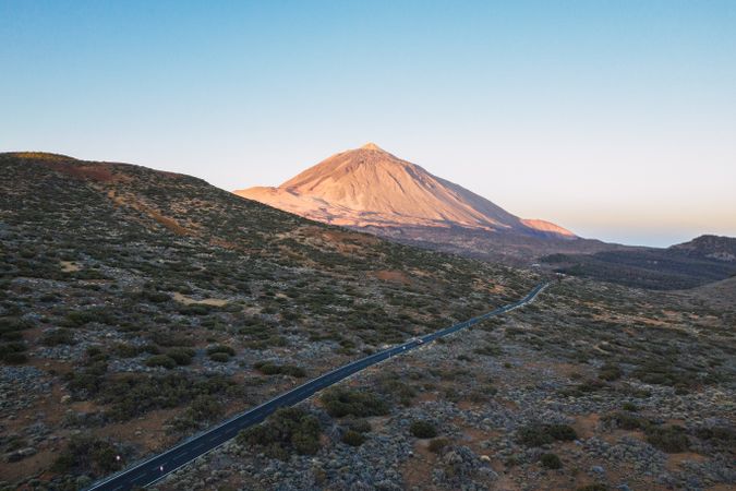Road and mountain peak against blue sky