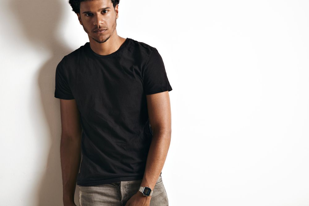 Male in dark t-shirt and jeans with serious expression