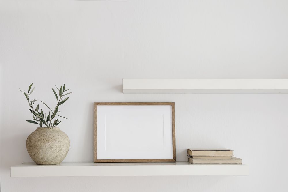 Shelf with mock up poster and vase with branches