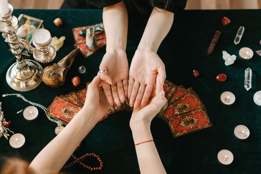Cropped image of fortune teller reading someone's palms