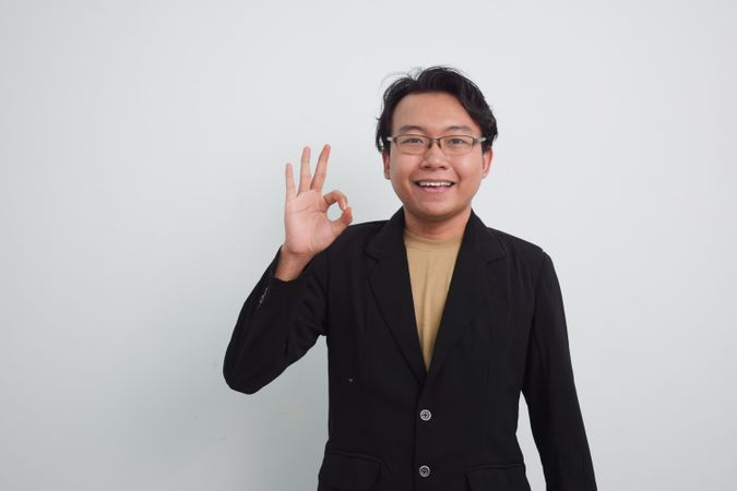 Asian Businessman doing ok hand sign
