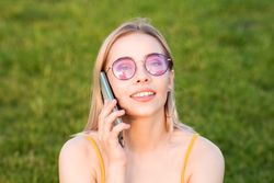 Woman in bright sunglasses talking on phone