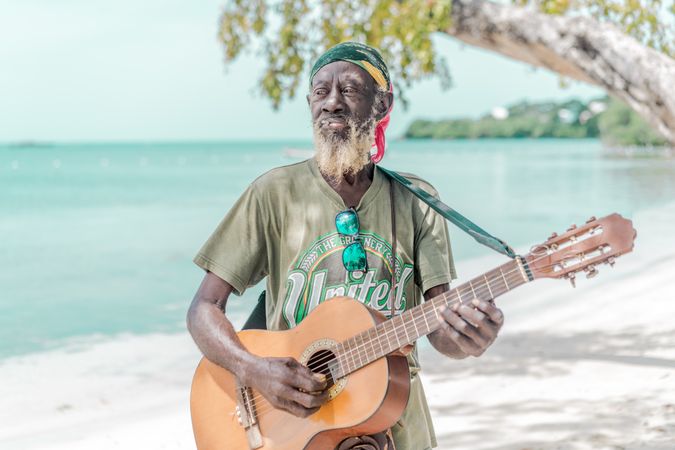 Jamaican man playing guitar