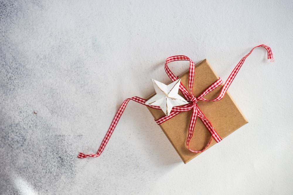 Ribbon wrapped Christmas gift with star ornament