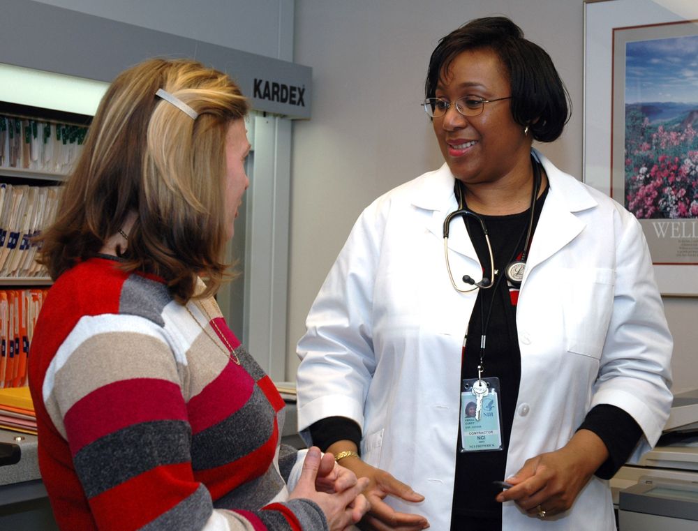 Bethesda, MD - USA, July 2006: A Black doctor speaks with a patient at the NCI