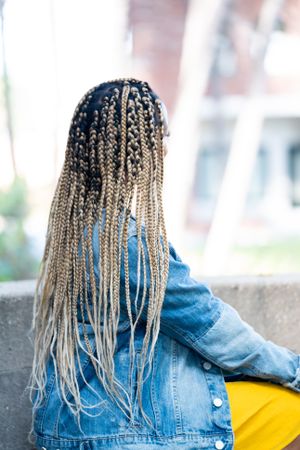 Back view of woman with long blonde box braids
