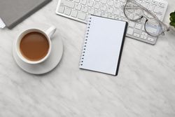 Notebook, Coffee, and Computer Keyboard on Table