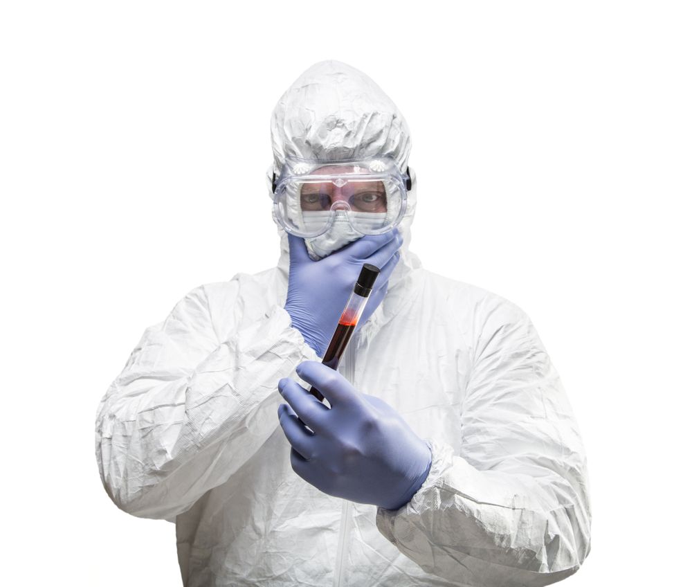 Man Wearing HAZMAT Protective Clothing Holding Test Tube Filled With Blood Isolated On A White Background.