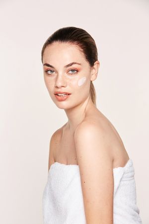 Amiable female taking care of face