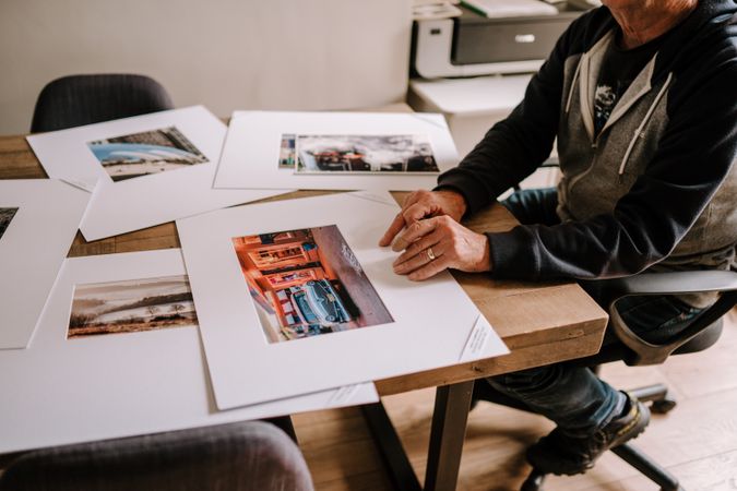 Man reviewing photos in his home office