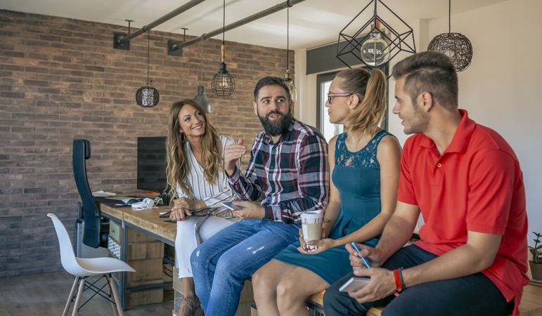 Office workers talking sitting at the table