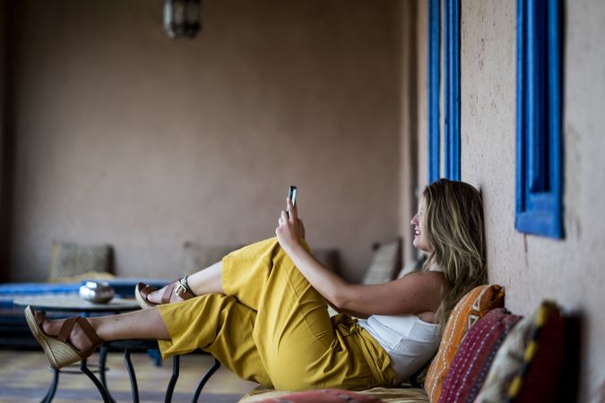 Woman with phone on oriental stone terrace