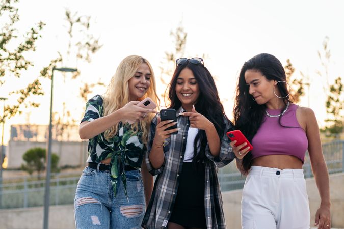 Women walking in the street using smartphones