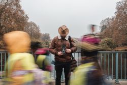 Male tourist with vintage camera near river