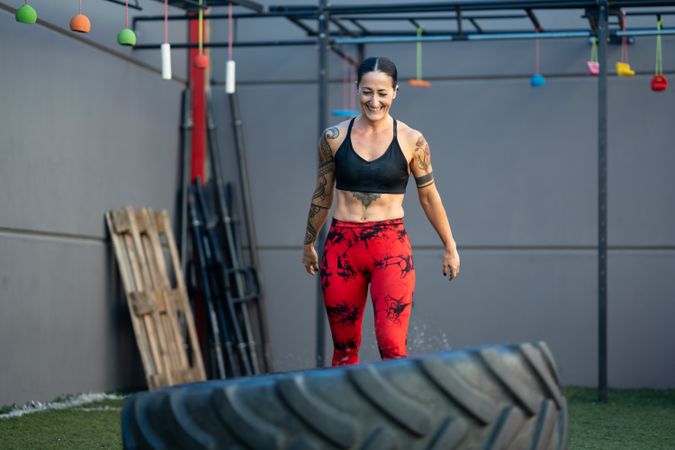 Strong woman working out with tire