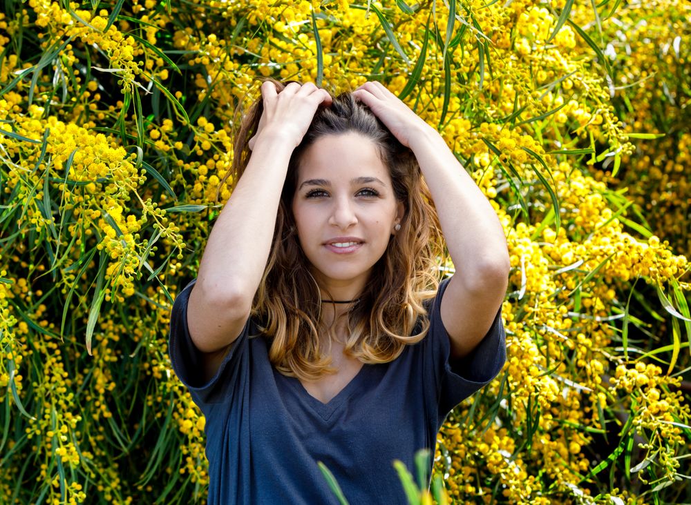Young female near blooming bushes