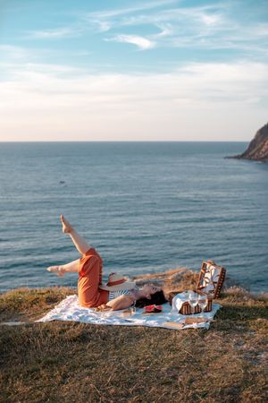 Woman resting in meadow on picnic