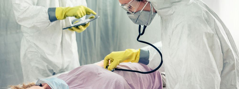 Doctors in a field hospital examining a patient