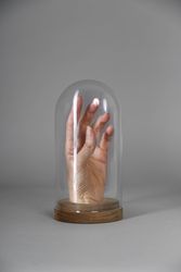 Drawing of a hand inside a cloche glass 5RXLDb