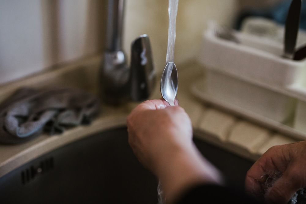 Anonymous woman washing dishes