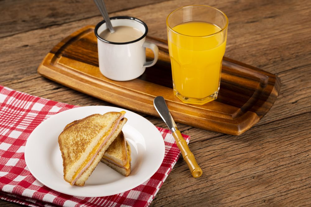 Grilled ham and cheese. Sandwich with cheese and ham on grill.